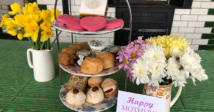 Afternoon Tea by Beamish Museum laid out on table with greetings card  and flowers in a vase.